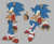 Size: 2048x1676 | Tagged: safe, artist:hibiscuit-rose, sonic the hedgehog, blushing, fingerless gloves, grey background, jacket, looking at viewer, male, posing, redesign, simple background, smile, solo, standing, tan skin, thumbs up, top surgery scars, trans male, transgender