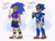 Size: 1966x1492 | Tagged: safe, artist:graves-yard, metal sonic, sonic the hedgehog, human, abstract background, black sclera, character name, clenched fist, cyborg, duo, humanized, looking offscreen, smile, standing, tan skin, v sign