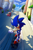 Size: 850x1280 | Tagged: safe, artist:kelskora, sonic the hedgehog, hedgehog, city escape, sonic adventure 2, 2016, abstract background, building, car, clouds, daytime, male, outdoors, smile, solo, tree, vehicle